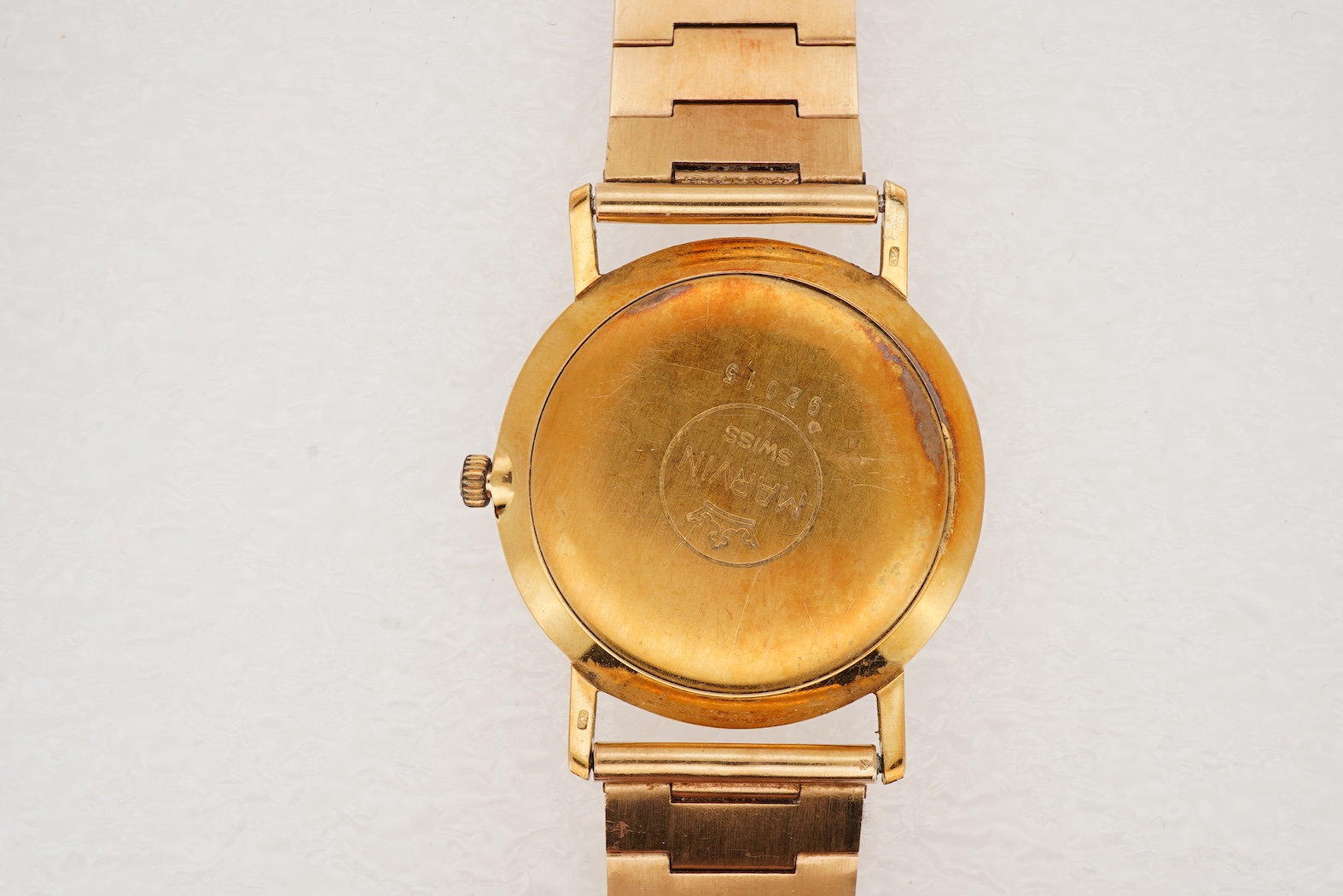 A gentleman's Swiss 18k gold Marvin manual wind dress wrist watch, with a Swiss 18k gold fancy brick link bracelet